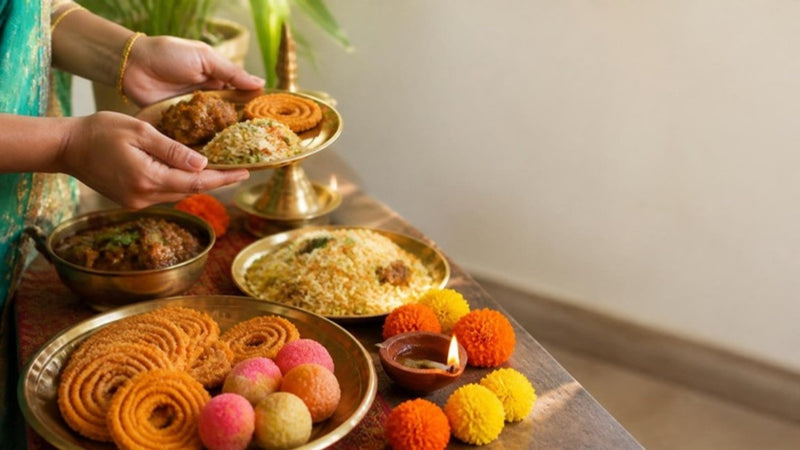 Deepavali open house table with murukku, laddu and briyani, a reminder of festive weight gain