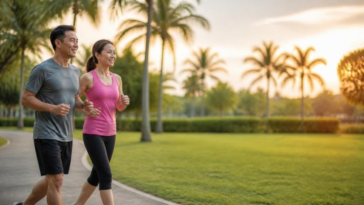 Malaysian couple brisk walking in a taman park at sunset, a simple way to lose belly fat